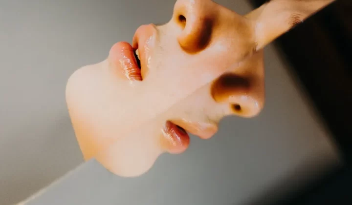 A woman's face is reflected in a mirror