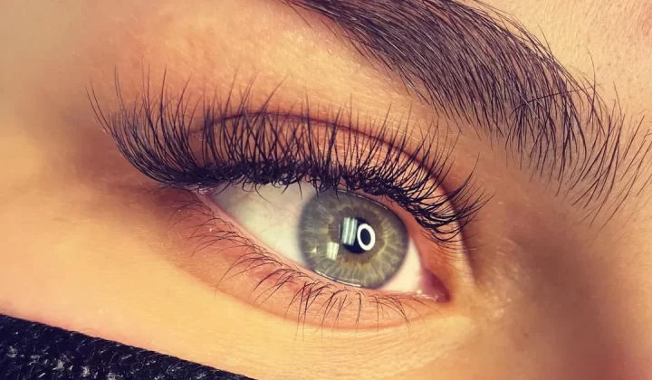 a close up of a person's eye with long lashes