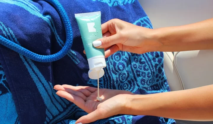 person holding white plastic tube bottle