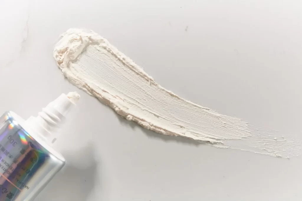 a bottle of cream next to a tube of cream