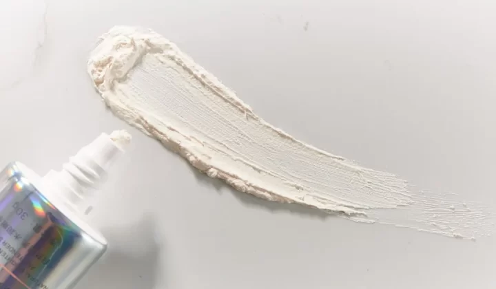 a bottle of cream next to a tube of cream